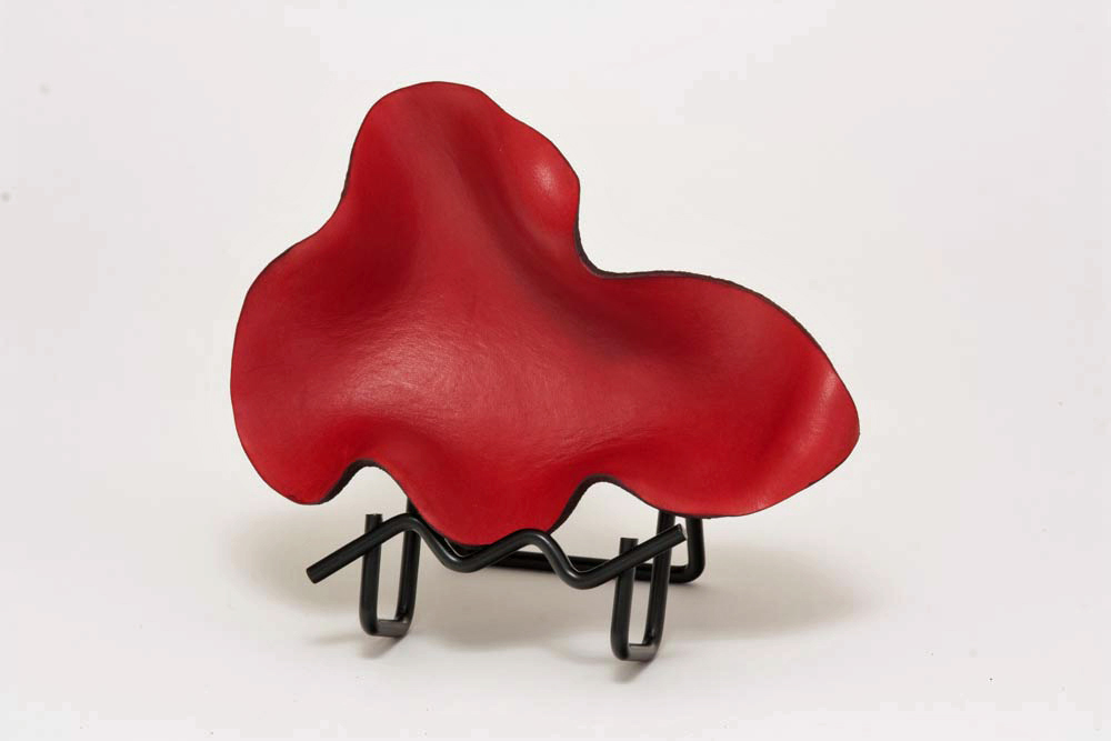 Business card holder, red free form.